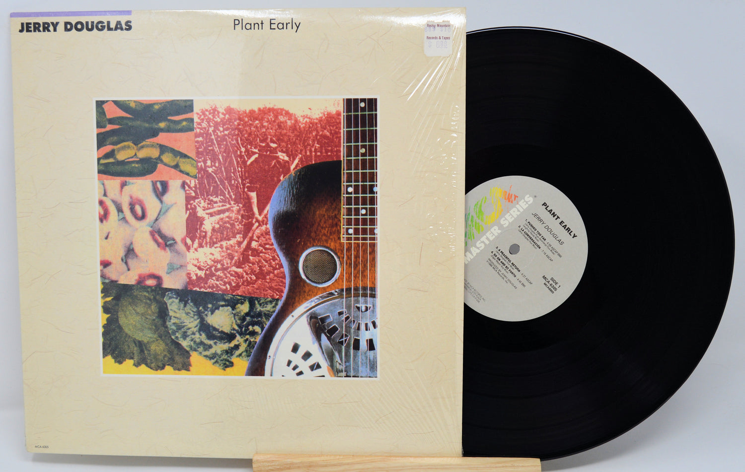 Vinyl record with cover featuring a guitar and colorful design, by Jerry Douglas.