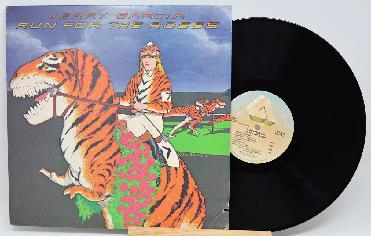 Jerry Garcia's 'Run For The Roses' vinyl record LP, showing the illustrated album cover on the left and the black vinyl record partially pulled out on the right.