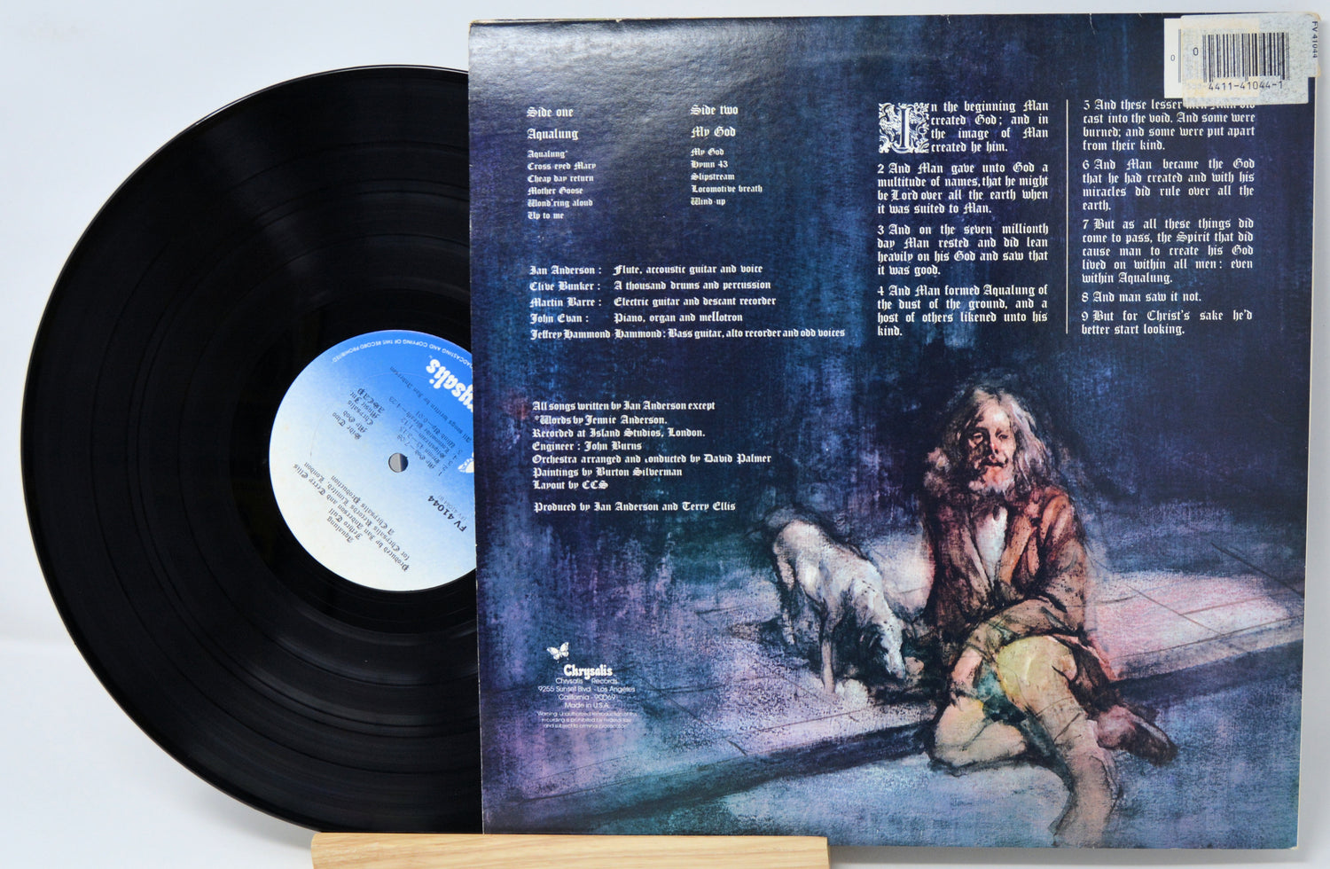 Vinyl record with a cover featuring an illustration of a person and a dog in a dimly lit room.