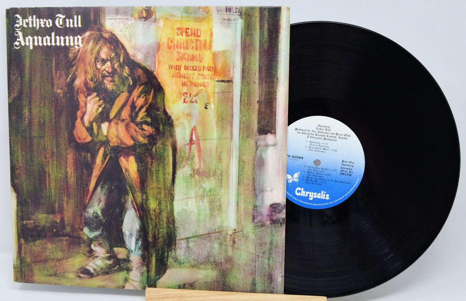 Vinyl record with cover featuring a person in a robe and album title 'Aqualung' by Jethro Tull.