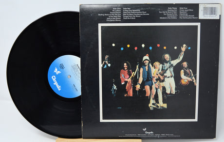 Vinyl record with a cover featuring a band and colorful lights on a white background