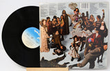 Vinyl record with a colorful cover featuring people in various poses.