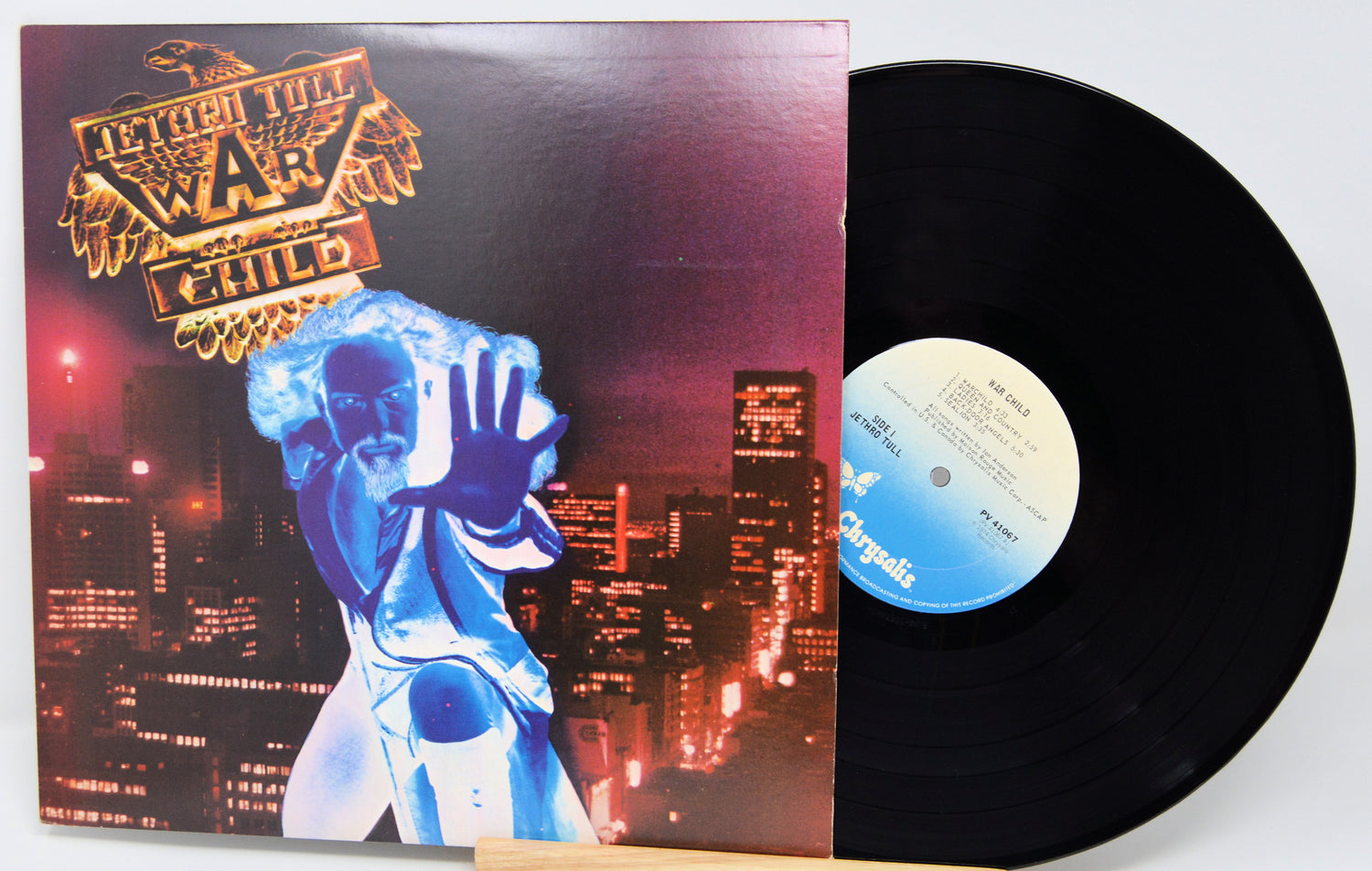 Vinyl record with a colorful cover featuring a person in a blue suit against a cityscape.