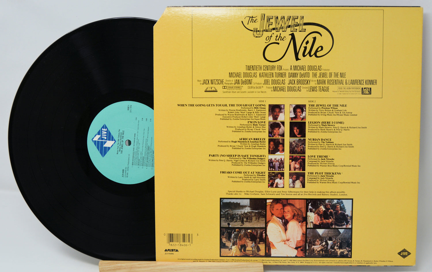 Vinyl record with yellow cover featuring text and images on a light gray background