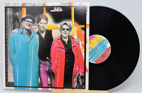 Used vinyl record of 'Catholic Boy' by Jim Carroll with a photo of the artist and two others on the cover, set against a white background.