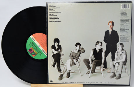 Vinyl record with a cover featuring a band sitting together, on a white background.