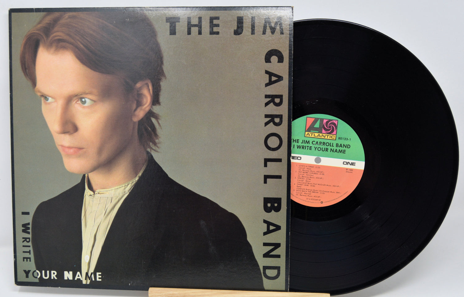 Vinyl record and cover of 'The Jim Carroll Band' with a portrait on the cover