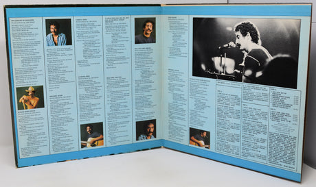 Vinyl record sleeve with black and white photos and text on a white background
