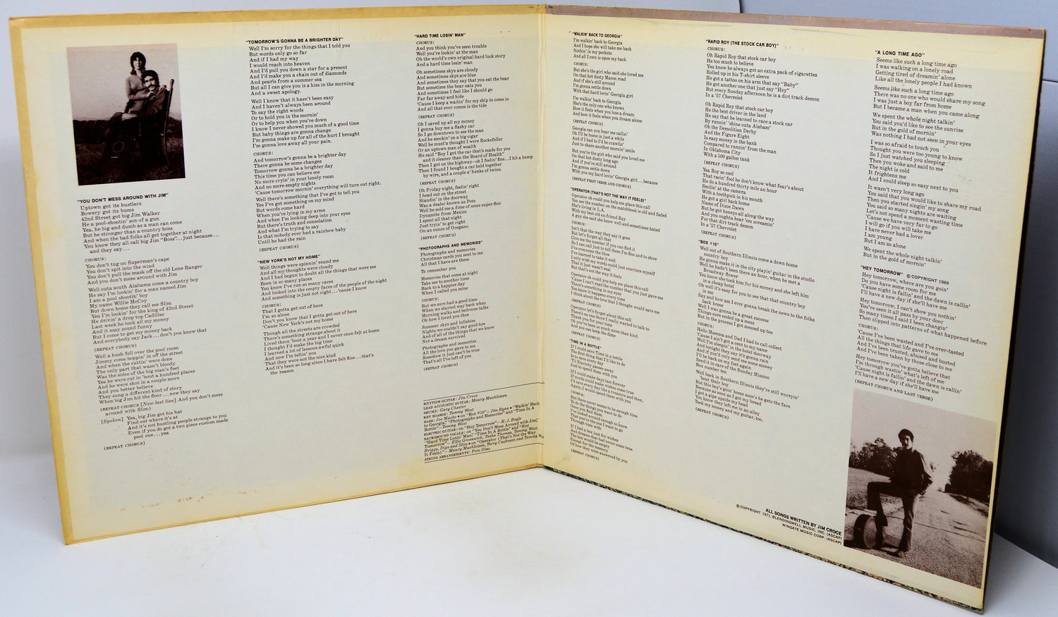 Open book with text and two black and white photos on a white surface