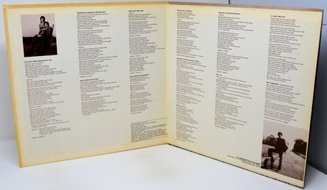 Open book with text and two black and white photos on a white surface