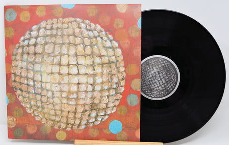 Front cover of Jim O'Rourke Eureka vinyl LP with record partially visible, featuring vibrant textured artwork