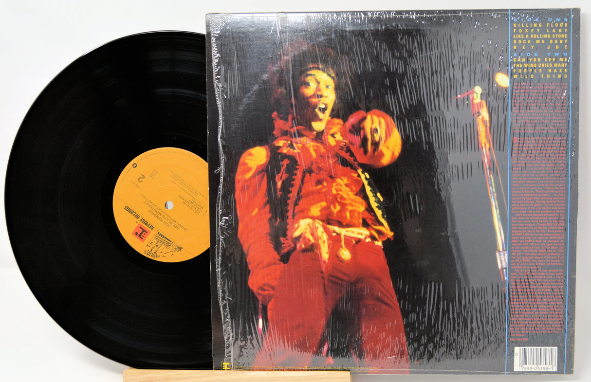 Vinyl record with a cover featuring a person in red attire on a white background