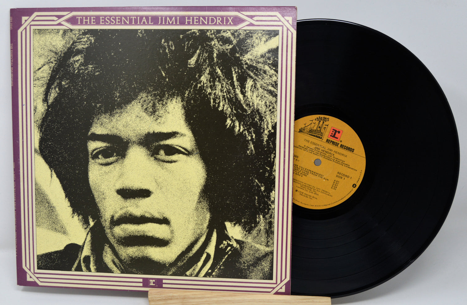 Vinyl record with a colorful cover featuring four band members.