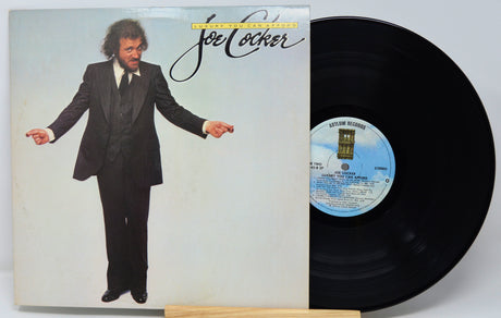 Vinyl record with cover featuring a man in a suit and album details.