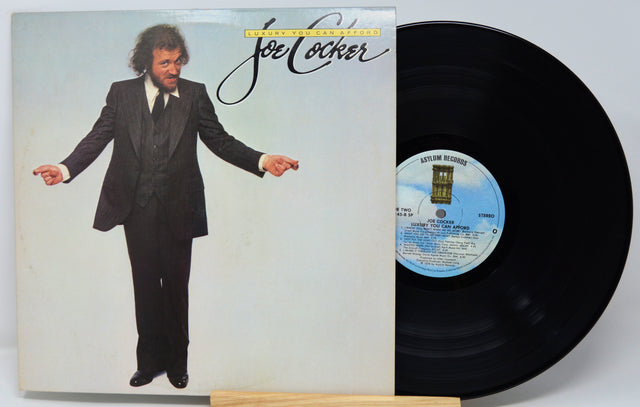 Vinyl record with cover featuring a man in a suit and album details.