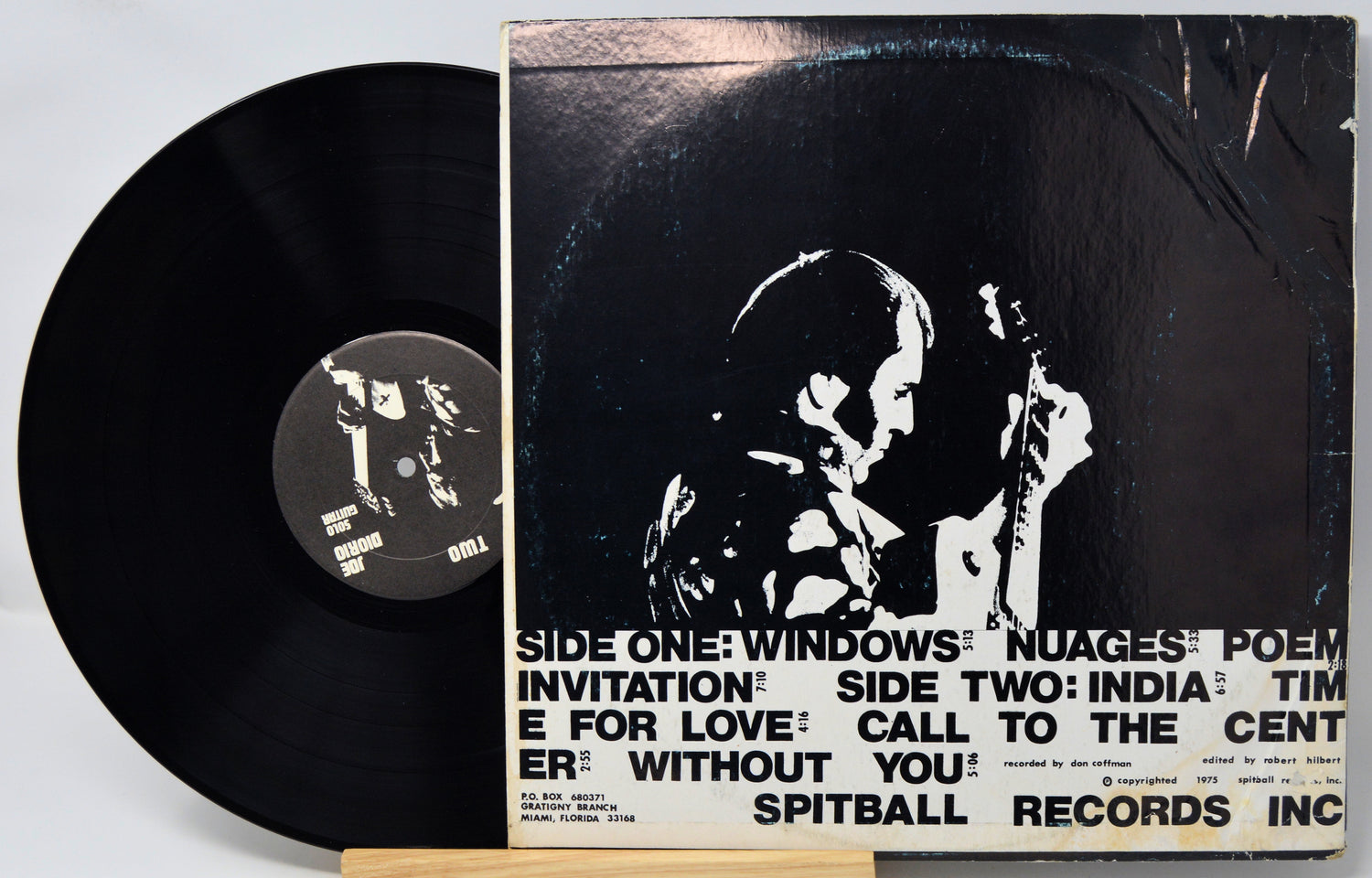 Vinyl record with cover featuring a black and white image of a couple and text.