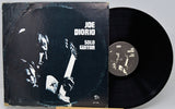 Vinyl record and cover with 'Joe Diorio Solo Guitar' on a gray background