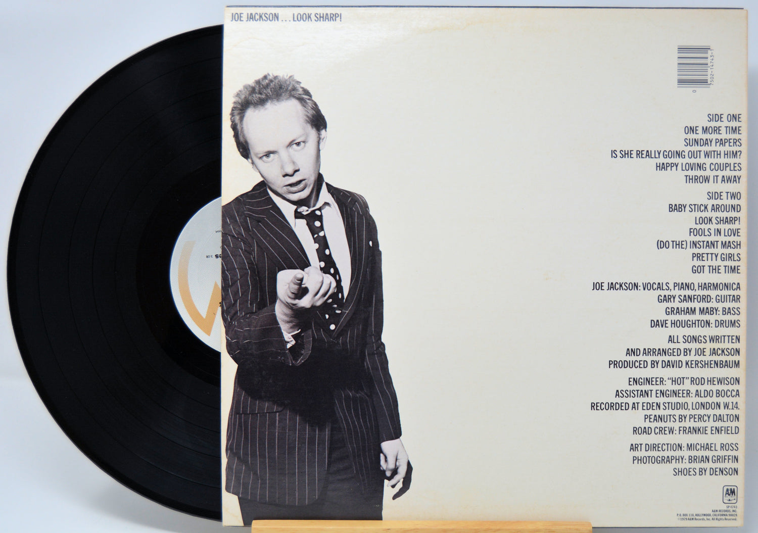 'Joe Jackson Look Sharp' Vinyl record with a cover featuring a person in a suit and text