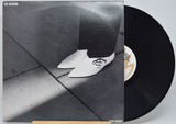 'Joe Jackson - Look Sharp' Vinyl record with a black and white photo of a person wearing shoes on the cover