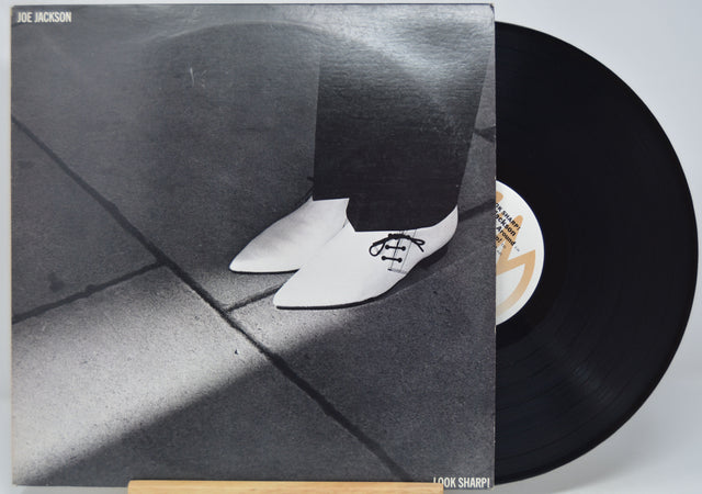 'Joe Jackson - Look Sharp' Vinyl record with a black and white photo of a person wearing shoes on the cover