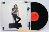 Vinyl record with a cover featuring a person and text, on a white background