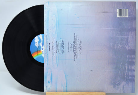'Joe Sample Voices In The Rain' Vinyl record with cover displaying text and a rainbow symbol on a light blue background