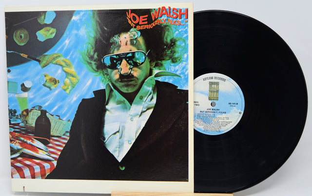 Vinyl record with colorful cover featuring a person and underwater scene