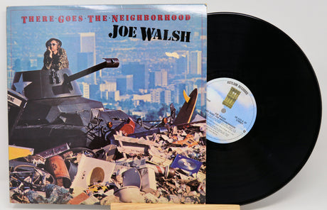 Vinyl record with cover featuring a cityscape and tank, titled 'There Goes the Neighborhood' by Joe Walsh.