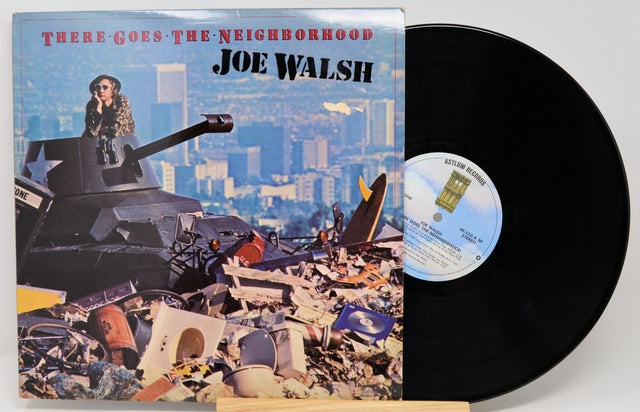 Vinyl record with cover featuring a cityscape and tank, titled 'There Goes the Neighborhood' by Joe Walsh.