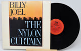 Vinyl record and cover for 'The Nylon Curtain' by Billy Joel on a white background