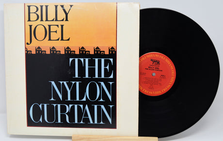 Vinyl record and cover for 'The Nylon Curtain' by Billy Joel on a white background