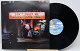 Elton John's 'Don't Shoot Me' vinyl record LP with its illustrated cover jacket and the black record partially pulled out, displayed on a light gray background.