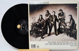 Vinyl record with Elton John 'Leather Jackets' album cover featuring a group of people and motorcycles.