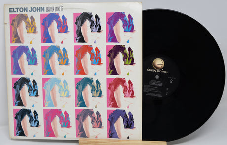 Vinyl record with a colorful cover featuring a grid of images and 'Elton John' branding.