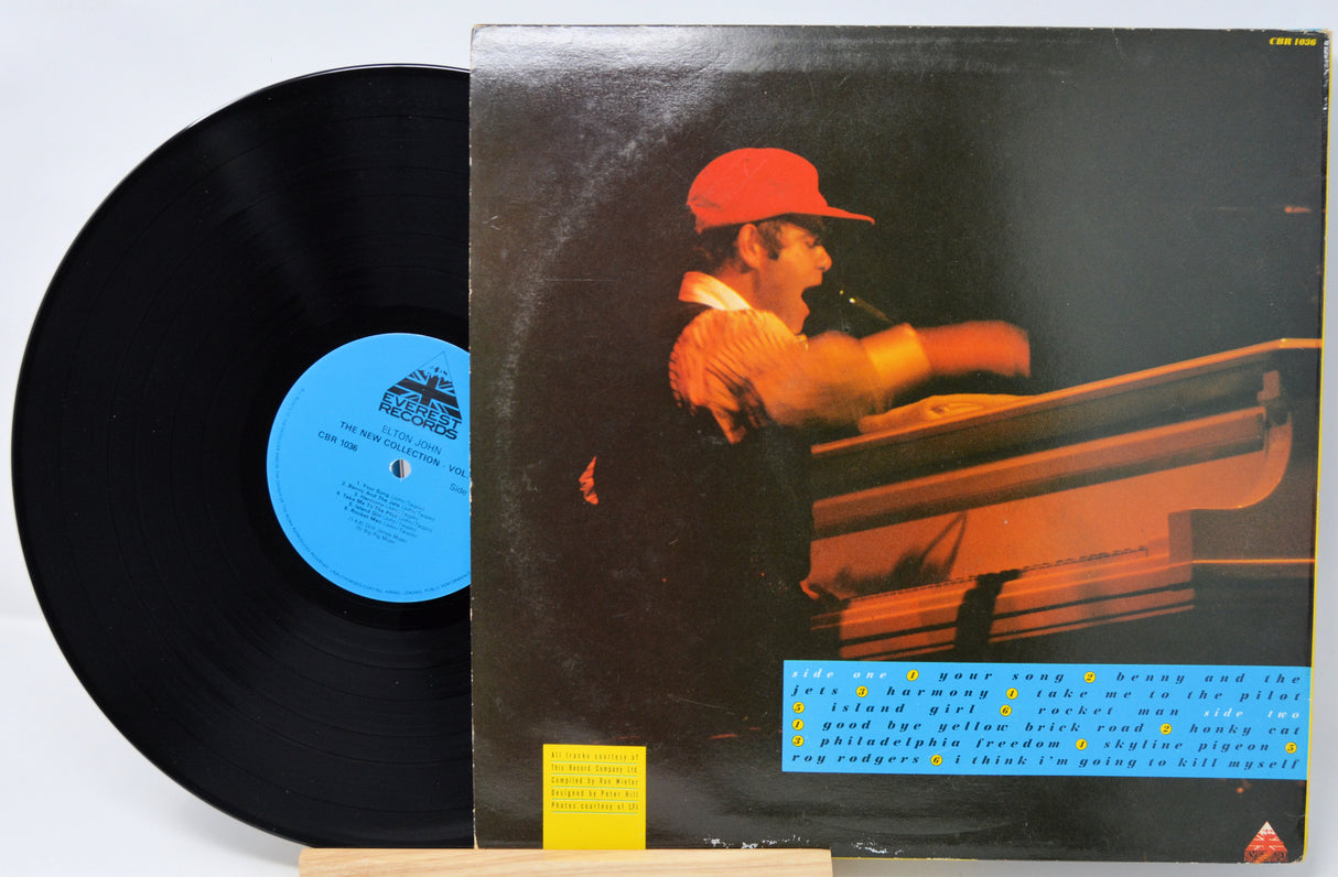 Vinyl record with a blue label and cover featuring a person with a red cap.