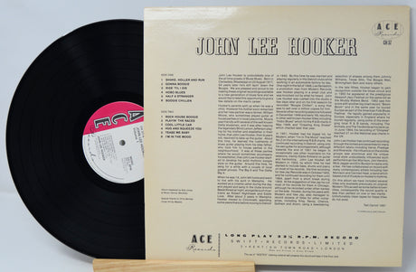 Vinyl record with its cover displaying 'John Lee Hooker' on a light gray background