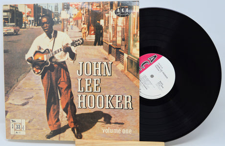 Vinyl record and cover featuring John Lee Hooker with a city street scene on the cover.