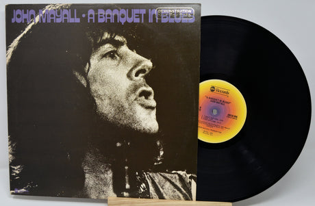 Vinyl record with cover featuring a black and white portrait and album details.