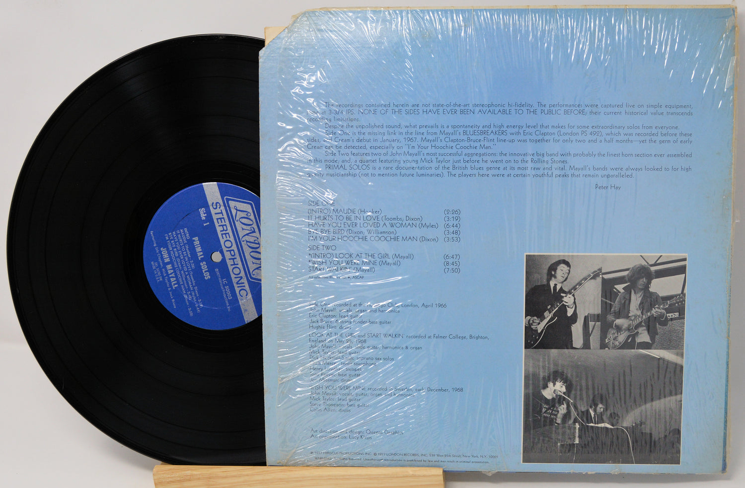 Vinyl record with blue label and cover showing text and images of musicians.