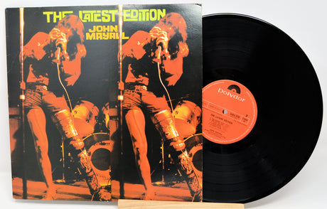 Vinyl record with cover featuring a musician and text 'The Latest Edition John Mayall' on a white background.