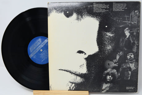 Vinyl record with a black and white cover featuring a group of people.