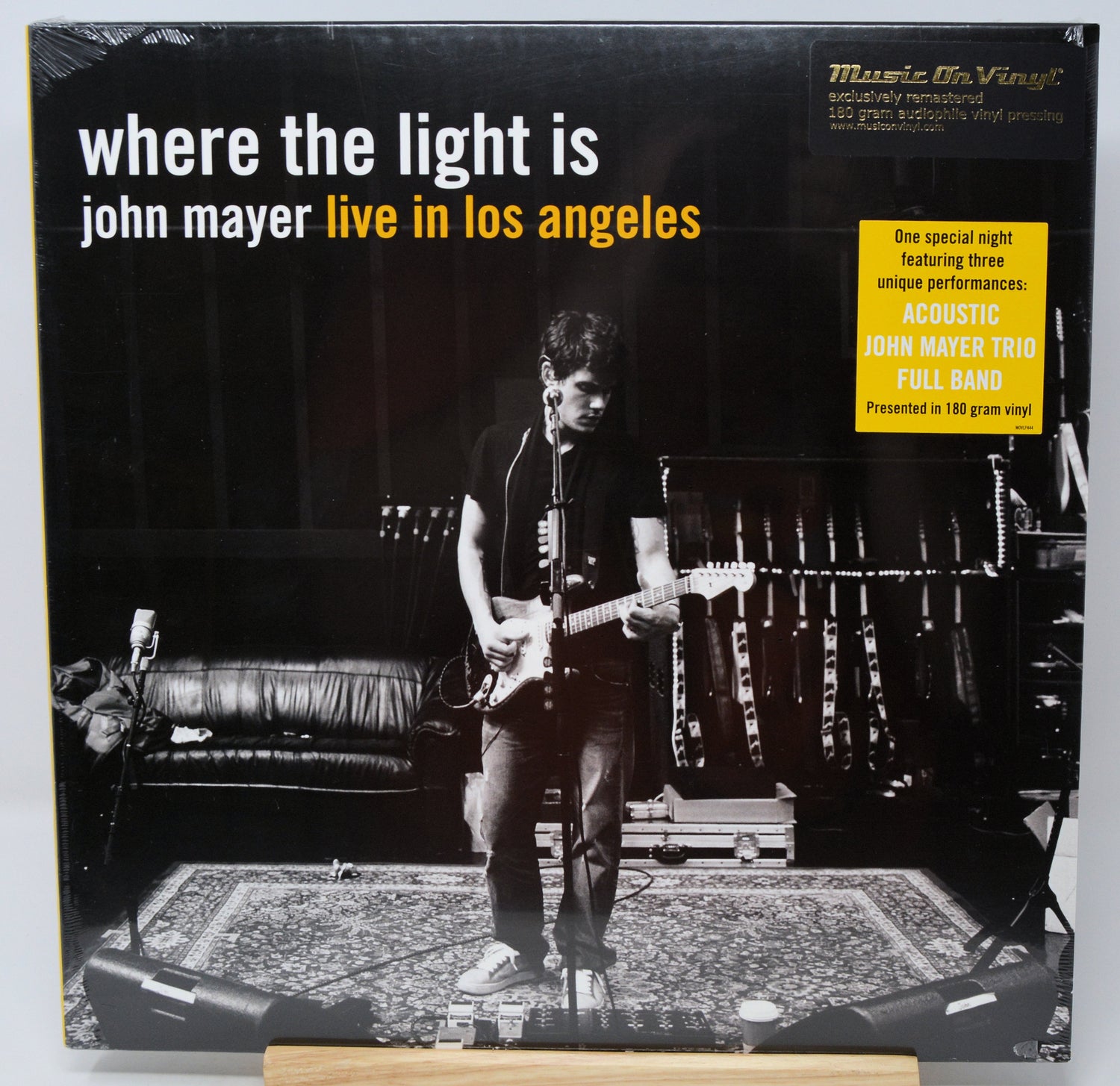 Vinyl record album cover for 'where the light is john mayer live in los angeles' with a black-and-white photo of a guitarist performing on stage, plus a yellow 'Music On Vinyl' promotional sticker.