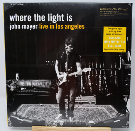 Vinyl record album cover for 'where the light is john mayer live in los angeles' with a black-and-white photo of a guitarist performing on stage, plus a yellow 'Music On Vinyl' promotional sticker.