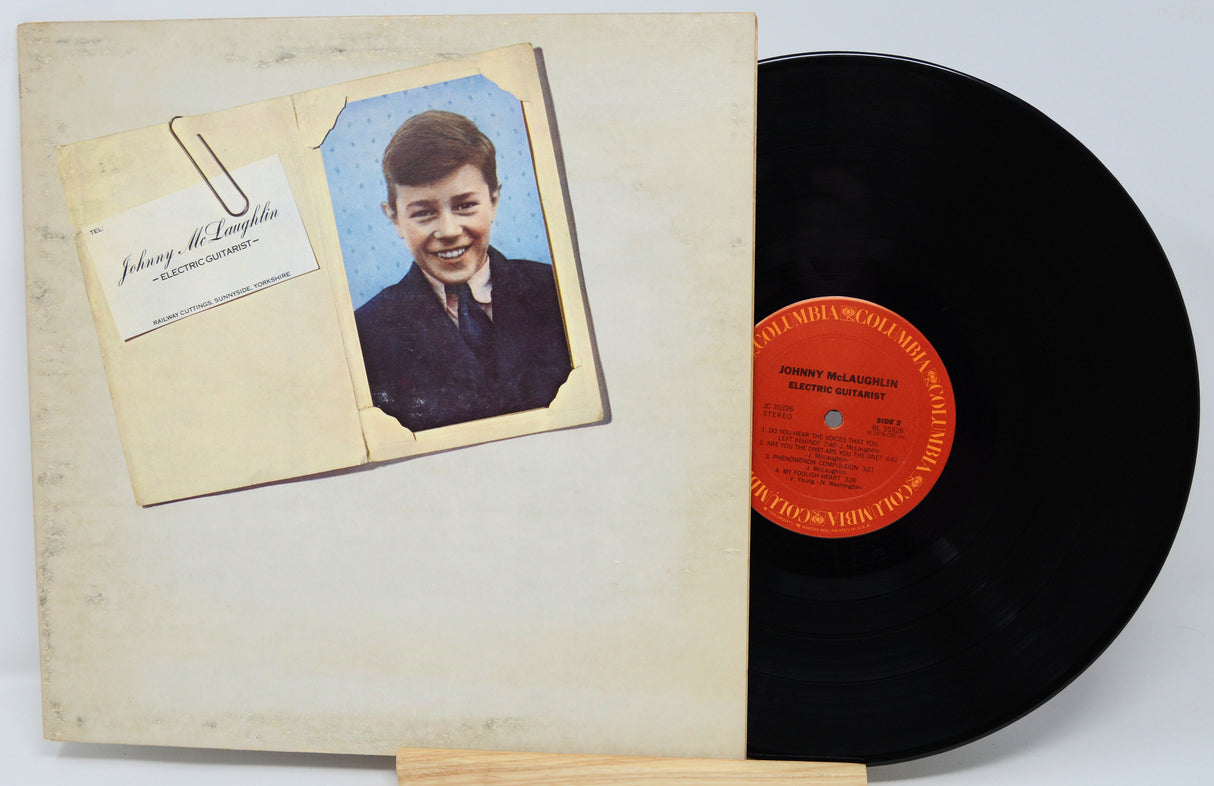 Vinyl record with a cover featuring a young boy's portrait on a light gray background