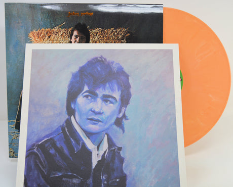 A vinyl record album with a blue-toned illustrated cover featuring a portrait of a man, shown with part of the orange record visible behind the sleeve.