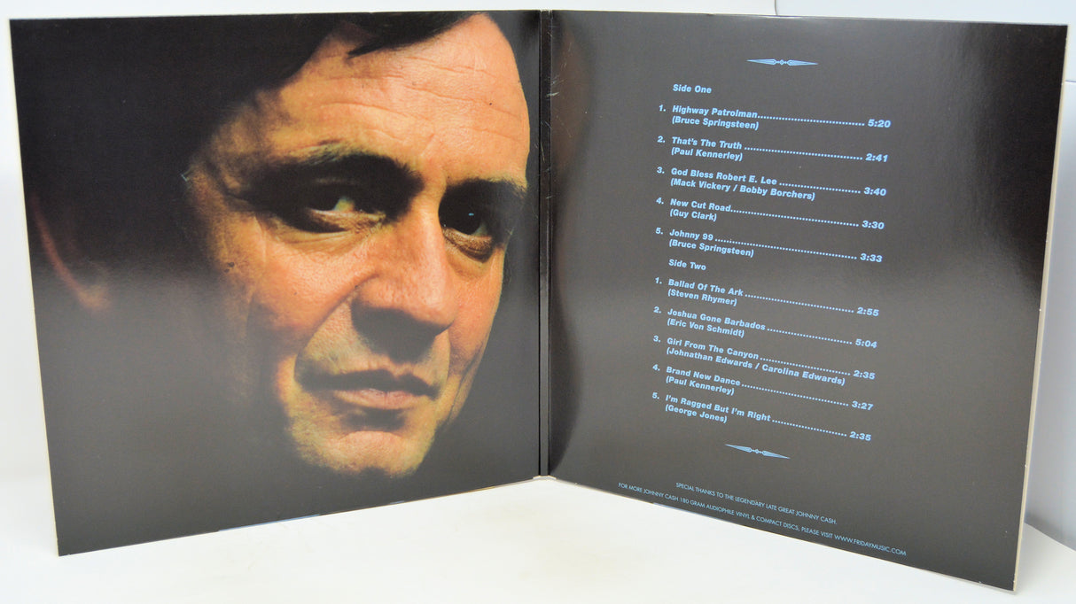 An open vinyl record sleeve or booklet showing a close-up portrait of a man on the left page and a tracklist on the right page, photographed against a plain light background.