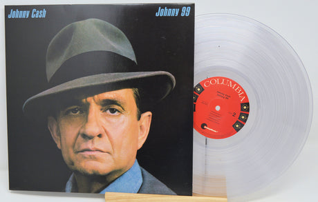 Johnny Cash 'Johnny 59' vinyl record album with the black-and-white cover art standing next to a translucent clear LP on a small wooden stand. The record label shows Columbia branding.