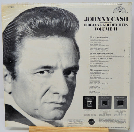 Vinyl record cover featuring Johnny Cash with text about 'Original Golden Hits Volume II'.
