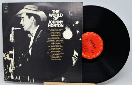 Vinyl record with cover featuring a cowboy and text, on a light gray background