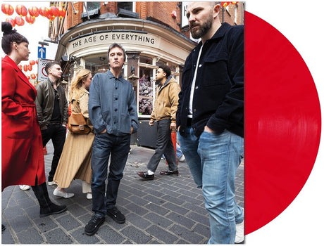 People on a street with a red vinyl record on the right